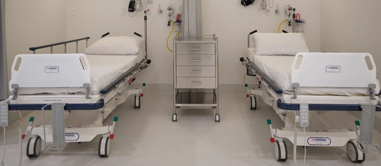 OMS Specialists Newmarket clinic — recovery bay with two patient trolleys in the purpose-built surgical environment