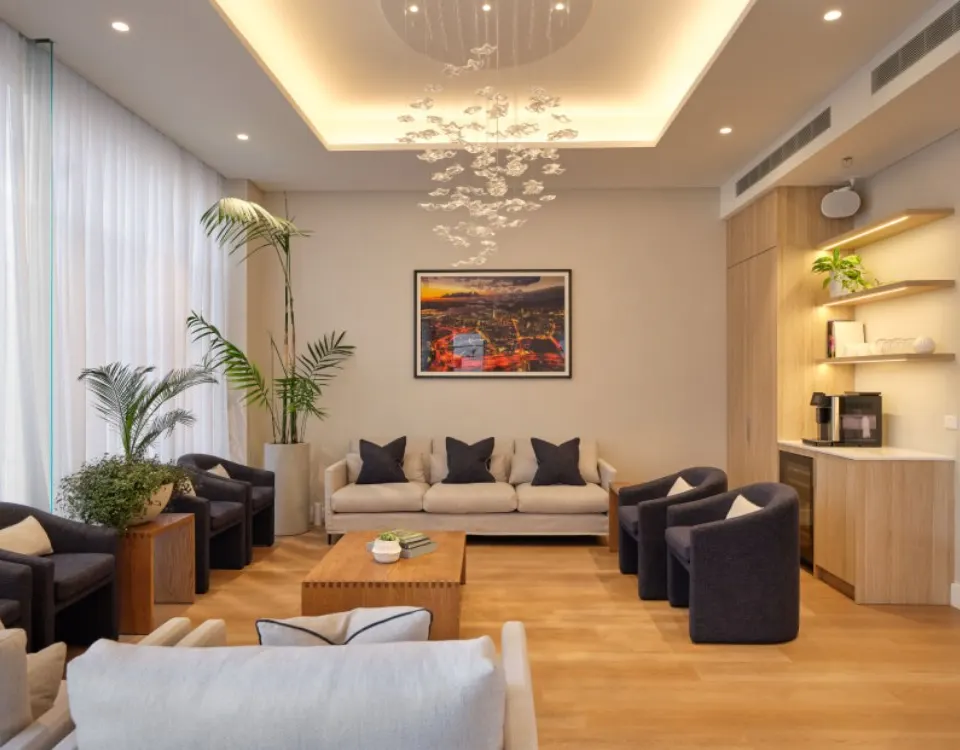 The OMS Specialists patient lounge in Newmarket — warm interior with chandelier and comfortable seating.